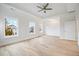 This bedroom features hardwood floors, recessed lighting, and three windows at 1010 Coleman Place Dr, Roswell, GA 30075