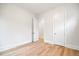 Bright bedroom featuring hardwood floors, and two doorways that provide access to other rooms at 1010 Coleman Place Dr, Roswell, GA 30075