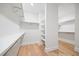 Spacious walk-in closet with built in shelving and hardwood floors at 1010 Coleman Place Dr, Roswell, GA 30075