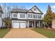 Charming two-story home with a two-car garage and meticulously landscaped front yard at 1010 Coleman Place Dr, Roswell, GA 30075