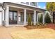 Charming front porch with brick accents and a beautifully landscaped entrance at 1010 Coleman Place Dr, Roswell, GA 30075