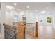 Hallway with hardwood floors, wood and metal railing, and views into multiple rooms at 1010 Coleman Place Dr, Roswell, GA 30075