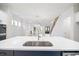 Bright, open-concept kitchen with quartz countertops and stainless steel appliances overlooking living area at 1010 Coleman Place Dr, Roswell, GA 30075