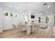Open-concept living and dining area with fireplace and hardwood floors at 1010 Coleman Place Dr, Roswell, GA 30075