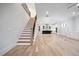 Spacious living area with staircase featuring wood and iron accents, connecting to kitchen at 1010 Coleman Place Dr, Roswell, GA 30075