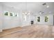 Spacious living room with fireplace, chandelier, large windows, and open layout at 1010 Coleman Place Dr, Roswell, GA 30075