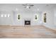 Open-concept living room with a fireplace, built-in cabinets, and hardwood floors at 1010 Coleman Place Dr, Roswell, GA 30075