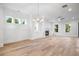 Bright living area featuring a fireplace and seamlessly flowing hardwood floors at 1010 Coleman Place Dr, Roswell, GA 30075