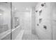 Large walk-in shower with white marble tile, multiple shower heads, and built in shelves at 1010 Coleman Place Dr, Roswell, GA 30075