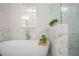 Luxurious bathroom with a soaking tub, marble accents, and a sleek shower at 204 Phillips Ln, Alpharetta, GA 30009