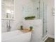 Elegant bathroom showcasing a soaking tub, glass shower, and marble accents at 204 Phillips Ln, Alpharetta, GA 30009