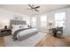 Bright bedroom with a large bed, a ceiling fan, and lots of natural light from two windows at 204 Phillips Ln, Alpharetta, GA 30009