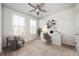 Bedroom with ceiling fan, large windows and an adjacent desk creating a functional workspace at 204 Phillips Ln, Alpharetta, GA 30009