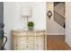 Elegant entryway featuring a decorative table, lamp, and view of the staircase at 204 Phillips Ln, Alpharetta, GA 30009