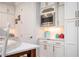 Bright kitchenette featuring white cabinets, stainless steel appliances, and modern finishes at 204 Phillips Ln, Alpharetta, GA 30009