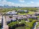 An aerial view of a community with golf course, water feature and cityscape in the distance at 400 17Th Nw St # 2029, Atlanta, GA 30363