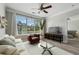 Open-concept living room with large windows, ceiling fan, and view to bedroom at 400 17Th Nw St # 2029, Atlanta, GA 30363