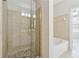 Modern glass shower with tiled walls, pebble floor, and a view into the bathroom at 400 17Th Nw St # 2029, Atlanta, GA 30363