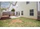 A well-maintained lawn and a patio with a wood rack are featured in the fenced backyard at 540 Broughton Dr, Canton, GA 30114