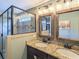 Bathroom featuring a double vanity, framed mirrors, a tiled shower with glass door at 540 Broughton Dr, Canton, GA 30114
