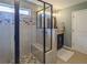 Bathroom featuring a stand-up shower with a glass door and built-in bench seat at 540 Broughton Dr, Canton, GA 30114