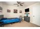 This is a bedroom with a ceiling fan, a bed, wall art and a dresser with a TV at 540 Broughton Dr, Canton, GA 30114