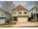Charming two-story home with a light green exterior, stylish shutters and a two-car garage at 540 Broughton Dr, Canton, GA 30114