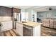 An open kitchen with granite countertops and stainless appliances overlooks the living room at 540 Broughton Dr, Canton, GA 30114