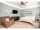 Cozy main bedroom boasts a ceiling fan, lounge chair, and soft, neutral decor at 540 Broughton Dr, Canton, GA 30114