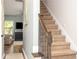 A carpeted staircase with a dark wooden banister leads to the upper level of the home at 540 Broughton Dr, Canton, GA 30114