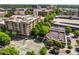 Overhead shot of a modern building and its surrounding cityscape, showcasing nearby businesses and landscaping at 201 W Ponce De Leon Ave # 303, Decatur, GA 30030
