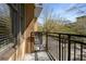 Comfortable balcony with wrought iron railing overlooking the street and neighborhood greenery in the distance at 201 W Ponce De Leon Ave # 303, Decatur, GA 30030