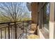 Relaxing outdoor balcony featuring neutral patio furniture and a wrought iron railing with neighborhood views at 201 W Ponce De Leon Ave # 303, Decatur, GA 30030