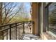 Open-air balcony with wrought iron railing offering scenic views of the neighborhood and surrounding trees at 201 W Ponce De Leon Ave # 303, Decatur, GA 30030