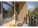 Cozy outdoor balcony showcasing a small patio table, brick facade, and exterior views from the large window at 201 W Ponce De Leon Ave # 303, Decatur, GA 30030