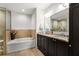 Bathroom features double sink vanity, a soaking tub, and a glass enclosed walk-in shower at 201 W Ponce De Leon Ave # 303, Decatur, GA 30030
