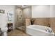 Modern bathroom features a glass-enclosed shower, soaking tub, and a white toilet and vanity at 201 W Ponce De Leon Ave # 303, Decatur, GA 30030