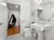 Bathroom with white tiled floors, vanity with vessel sink, and access to hallway and closet at 201 W Ponce De Leon Ave # 303, Decatur, GA 30030