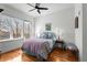 Bright bedroom with hardwood floors, a large window, and a comfortable bed with stylish linens at 201 W Ponce De Leon Ave # 303, Decatur, GA 30030