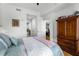 Bedroom with hardwood floors and stylish furnishings adjoins bathroom and dining area at 201 W Ponce De Leon Ave # 303, Decatur, GA 30030