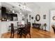 Bright dining area features modern lighting, wood floors, and seamlessly connects to the kitchen at 201 W Ponce De Leon Ave # 303, Decatur, GA 30030