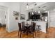 Bright dining area adjacent to the kitchen with hardwood floors and modern lighting at 201 W Ponce De Leon Ave # 303, Decatur, GA 30030