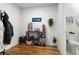 Hallway features sleek hardwood floors, and flows to a half bath with striking black and white tiled floors at 201 W Ponce De Leon Ave # 303, Decatur, GA 30030