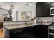 Kitchen featuring dark wood cabinets, stainless steel appliances, and breakfast bar at 201 W Ponce De Leon Ave # 303, Decatur, GA 30030