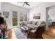 Bright living room with hardwood floors, outdoor view, and doorway to adjacent bedroom at 201 W Ponce De Leon Ave # 303, Decatur, GA 30030