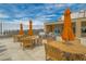 Inviting rooftop terrace with dining tables, umbrellas, outdoor grilling station, and scenic cityscape views at 201 W Ponce De Leon Ave # 303, Decatur, GA 30030