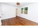 A bright bedroom with hardwood floors, white walls, and a window providing natural light at 2010 Bixby Se St, Atlanta, GA 30317