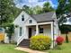 Inviting front porch with stained wood stairs and columns surrounded by colorful landscaping at 2010 Bixby Se St, Atlanta, GA 30317