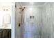 Modern shower area features light colored tile, bronze fixtures and a sleek glass enclosure at 2010 Bixby Se St, Atlanta, GA 30317