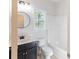 Clean bathroom featuring a shower-tub combo, dark vanity, and modern toilet at 288 Pine Way, Dallas, GA 30157
